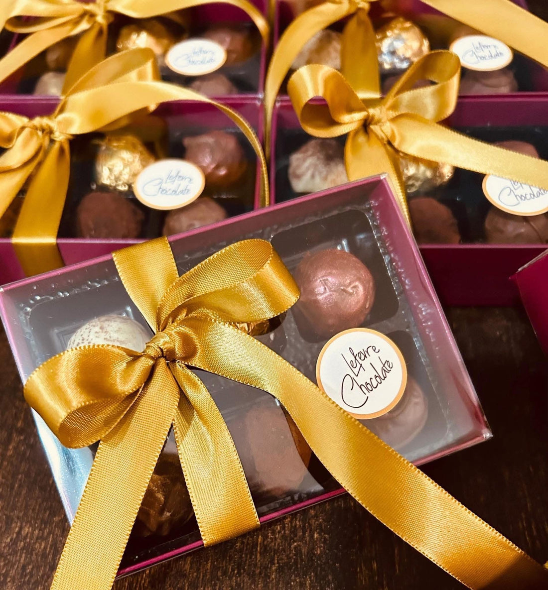 A luxury Lefevre Chocolate truffle gift box surrounded by revision notes and stationery — the perfect brain food for GCSE and A-Level exam season