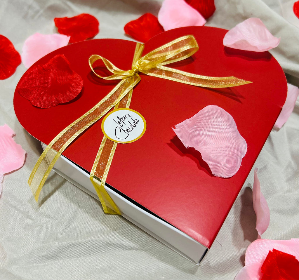 outside the box with gold ribbon Red heart-shaped gift box of 9 Lefevre Chocolate artisan Belgian chocolate truffles for Valentine's Day