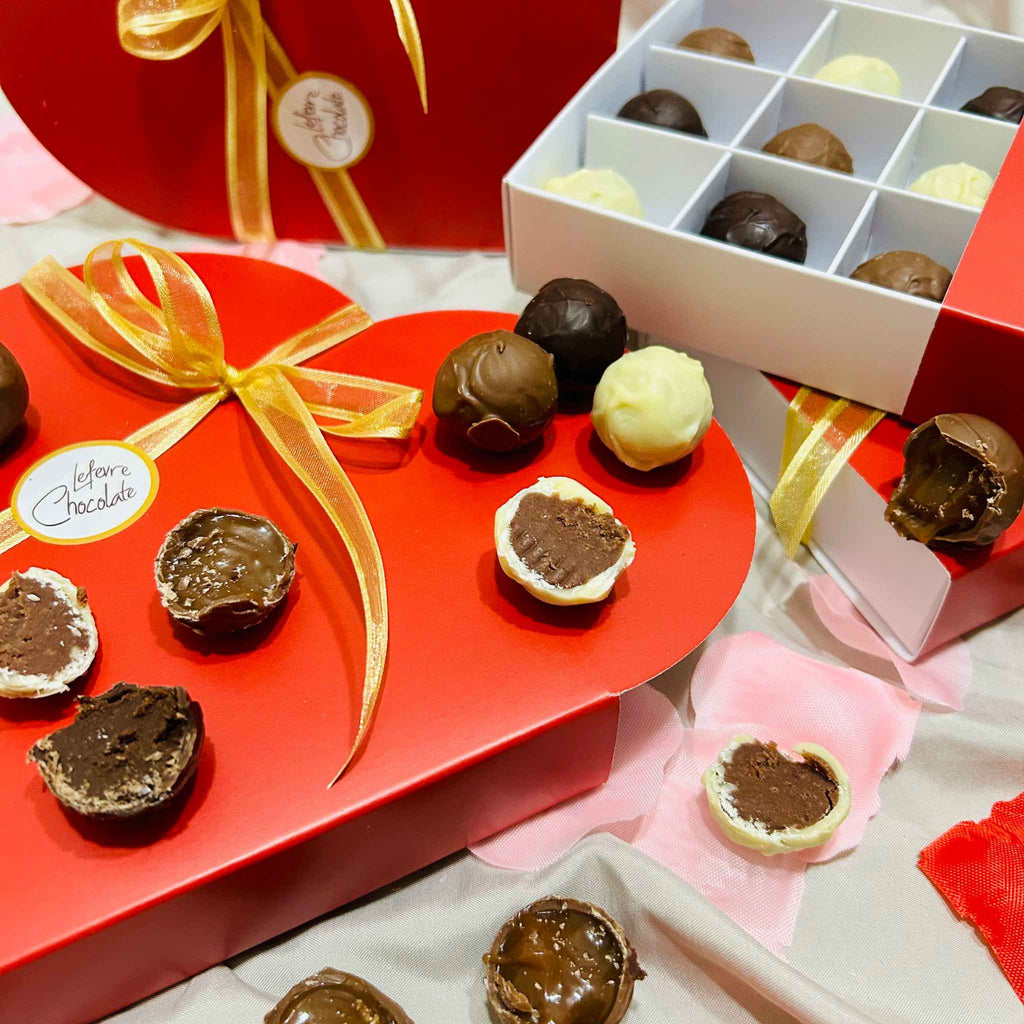 Red heart-shaped gift box of 9 Lefevre Chocolate artisan Belgian chocolate truffles for Valentine's Day showing the inside of truffles